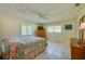 Spacious bedroom with a dresser, TV, and floral bedding at 3454 Country Walk Dr, Port Orange, FL 32129