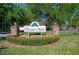 Country Walk community entrance sign with brick pillars and lush landscaping at 3454 Country Walk Dr, Port Orange, FL 32129