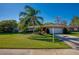 Brick house with palm tree, spacious lawn, and attached garage at 3454 Country Walk Dr, Port Orange, FL 32129