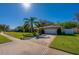 House with a white garage door and palm trees in front at 3454 Country Walk Dr, Port Orange, FL 32129