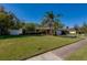 Landscaped yard with a large lawn and a brick house at 3454 Country Walk Dr, Port Orange, FL 32129