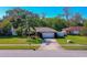 Single-story home with attached garage and well-manicured lawn at 3454 Country Walk Dr, Port Orange, FL 32129