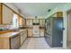 Galley kitchen with stainless steel appliances and light wood cabinets at 3454 Country Walk Dr, Port Orange, FL 32129