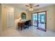 Home office with desk, tile floors, and sliding glass doors to screened porch at 3454 Country Walk Dr, Port Orange, FL 32129