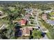 High-angle aerial view of a residential neighborhood with a golf course in the background at 392 Glen Abbey Ln, Debary, FL 32713