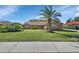 Single-story home with brick facade, palm tree, and lush green lawn at 392 Glen Abbey Ln, Debary, FL 32713