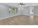 Spacious living room with wood-look tile floors and large window at 392 Glen Abbey Ln, Debary, FL 32713