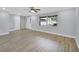 Living room with large front window, ceiling fan, and modern flooring at 392 Glen Abbey Ln, Debary, FL 32713