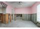 Unfinished bedroom with pink walls and exposed framing at 416 Lancaster Ave, Orange City, FL 32763