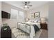 Bright bedroom with a comfortable bed, ceiling fan, and large windows at 4859 Nw 35Th Lane Rd, Ocala, FL 34482