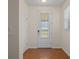 Inviting entryway with wood flooring, coat closet, and elegant front door at 4859 Nw 35Th Lane Rd, Ocala, FL 34482