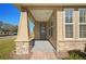 Charming house exterior with a covered porch and stone accents at 4859 Nw 35Th Lane Rd, Ocala, FL 34482
