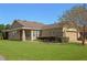 One-story house with brown siding, a screened porch, and lush lawn at 4859 Nw 35Th Lane Rd, Ocala, FL 34482