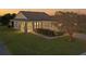 Tan one-story house with a brown roof, stone accents, and a two-car garage at 4859 Nw 35Th Lane Rd, Ocala, FL 34482