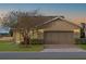 House exterior featuring a brown garage door and landscaping at 4859 Nw 35Th Lane Rd, Ocala, FL 34482