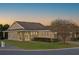 Tan one story house with a brown roof, stone accents and a two car garage at 4859 Nw 35Th Lane Rd, Ocala, FL 34482