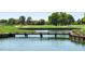 Serene golf course with a wooden bridge over calm water at 4859 Nw 35Th Lane Rd, Ocala, FL 34482