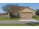 Single-story home with attached garage and well-manicured lawn at 4859 Nw 35Th Lane Rd, Ocala, FL 34482