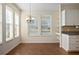 Bright kitchen with wood flooring, white cabinets, and a breakfast nook at 4859 Nw 35Th Lane Rd, Ocala, FL 34482