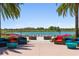 Seating area with a beautiful lake view and lush landscaping at 4859 Nw 35Th Lane Rd, Ocala, FL 34482
