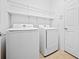 Convenient laundry room with washer, dryer, and overhead shelving at 4859 Nw 35Th Lane Rd, Ocala, FL 34482