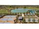 Aerial view of tennis courts and a community lake at 4859 Nw 35Th Lane Rd, Ocala, FL 34482