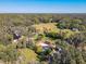 Aerial view of home on a large lot with a waterfront view and lush landscaping at 544 Stone Island Rd, Enterprise, FL 32725