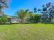 Large backyard with lush landscaping and screened patio at 544 Stone Island Rd, Enterprise, FL 32725