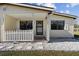 Close-up of the home's front porch with a white picket fence and welcome mat at 5570 Lancewood Dr, Port Orange, FL 32127