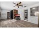 Bright living room with wood accent wall, ceiling fan, and tile flooring at 5570 Lancewood Dr, Port Orange, FL 32127