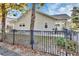 Side view of house with fenced yard and mature trees at 615 N Palmetto Ct, Deland, FL 32720