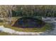 Small pond surrounded by trees and natural vegetation at 227 N Putnam Grove Rd, Oak Hill, FL 32759