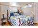 Bright bedroom with a metal bed frame and hardwood floors at 101 Fleming Ave, Port Orange, FL 32127