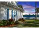 White house with blue shutters, waterfront view, and lush landscaping at 101 Fleming Ave, Port Orange, FL 32127