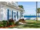 White house with blue shutters, waterfront view, and lush landscaping at 101 Fleming Ave, Port Orange, FL 32127