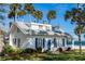 Bright white house with blue shutters, palm trees, and a manicured lawn at 101 Fleming Ave, Port Orange, FL 32127