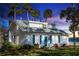 Charming white house with blue shutters, landscaped yard, and waterfront view at 101 Fleming Ave, Port Orange, FL 32127