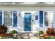 Front door with blue shutters and welcome sign at 101 Fleming Ave, Port Orange, FL 32127