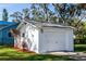 Detached white garage with single door and landscaping at 101 Fleming Ave, Port Orange, FL 32127