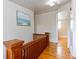 Upper hallway with hardwood floors and wooden railing at 101 Fleming Ave, Port Orange, FL 32127