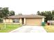 Tan house with a brown roof, one-car garage, and a small front yard at 1201 Buccaneer Ave, Deltona, FL 32725