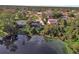 Aerial view of house near lake with lush trees at 1250 Baton Dr, Deltona, FL 32725