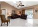 Relaxing living area with leather furniture, ceiling fan, and access to the pool at 126 Old Sunbeam Dr, South Daytona, FL 32119