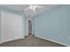 Bedroom with double door closet and ceiling fan at 1281 W New York Ave, Orange City, FL 32763