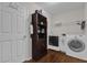 Laundry room with washer, dryer, and built-in shelving at 1281 W New York Ave, Orange City, FL 32763