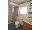 Bathroom with shower, toilet, and wood vanity at 1632 Bream Dr, Seville, FL 32190