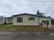 Tan mobile home with green shutters and a mailbox at 1632 Bream Dr, Seville, FL 32190