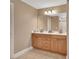 Double vanity bathroom with light wood cabinets and a large mirror at 1676 N Stone St, Deland, FL 32720