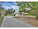 Long driveway leading to a single-story house with attached garage at 1676 N Stone St, Deland, FL 32720