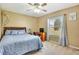 Bedroom with a queen-size bed, desk, and window at 1819 India Palm Dr, Edgewater, FL 32132